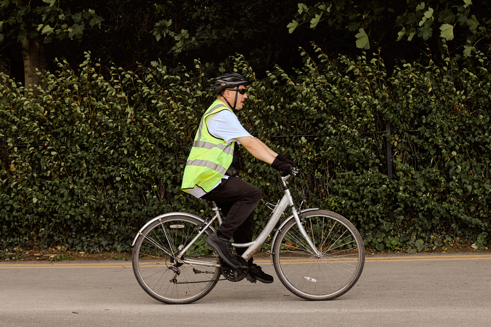 Someone riding a bicycle with helmet and high visability jacket